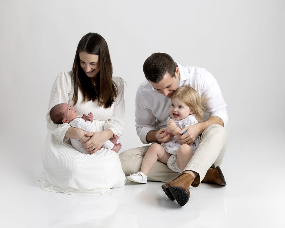 newborn family photographer sudbury ma studio parents admiring baby