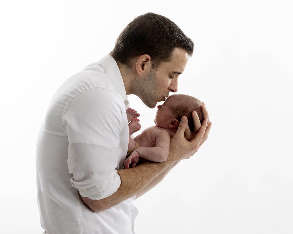 newborn photographer sudbury ma studio father kissing newborn