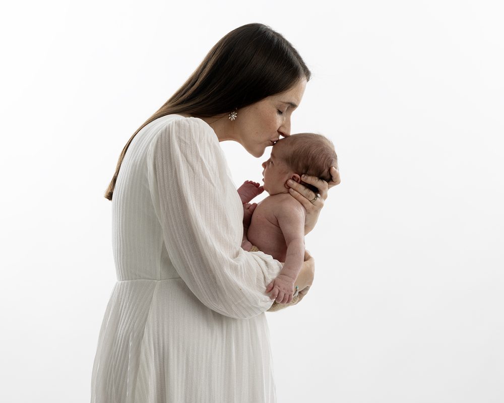 newborn photographer sudbury ma studio mother kissing newborn