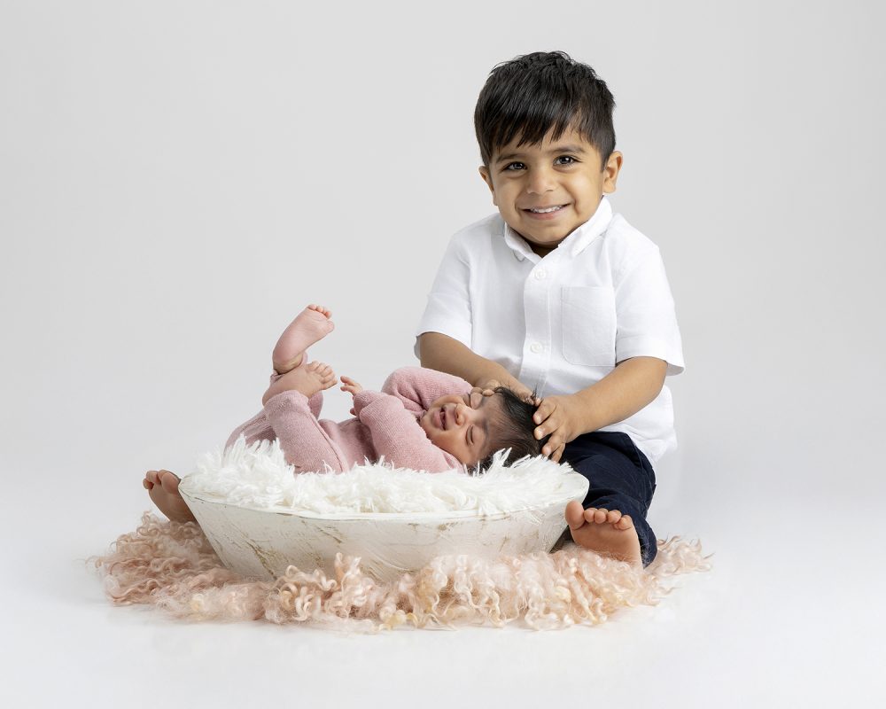 Sweet sibling moment during a newborn session in my Sudbury MA studio serving Boston Metrowest families.