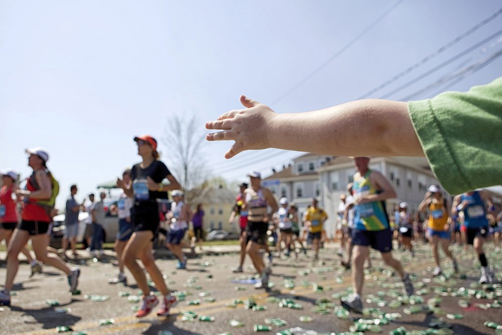 07 child reaching toward runners marathon